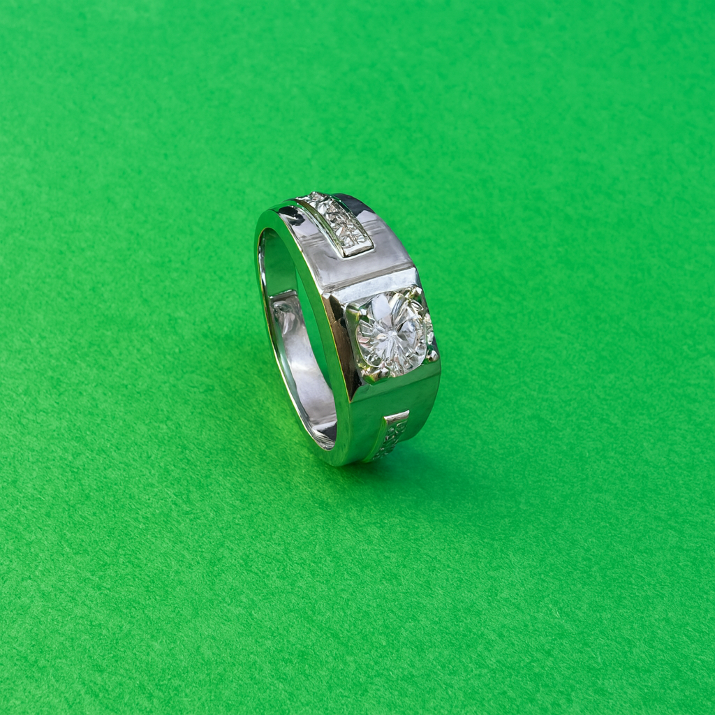 Silver ring with a diamond on a green fabric background