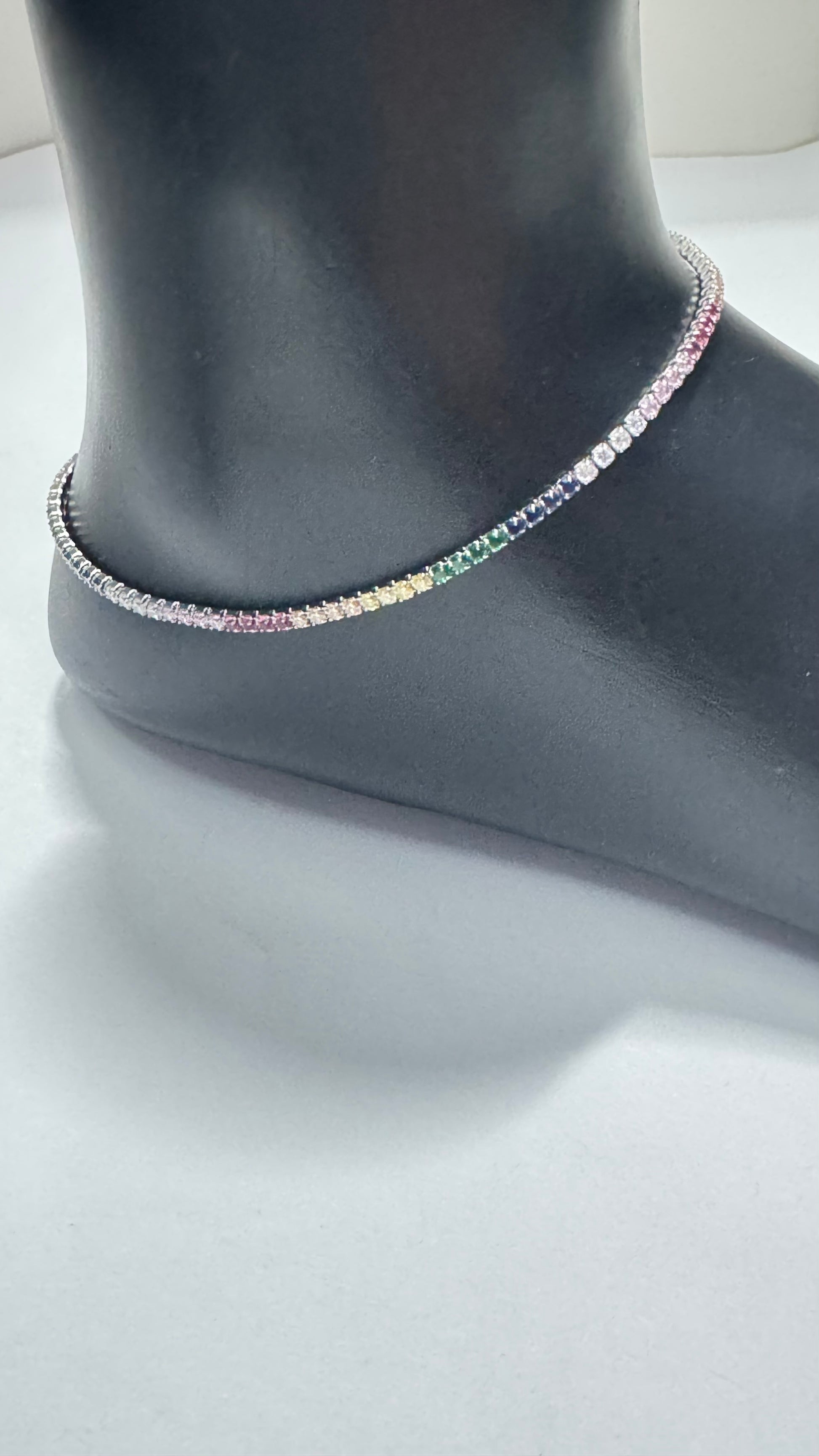 Necklace on a mannequin neck with a plain background