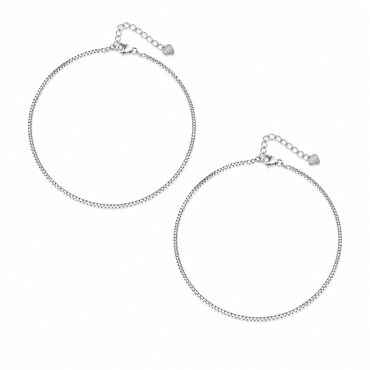 A pair of silver chain anklets with adjustable lobster clasp and heart-shaped charm details, displayed on a clean white background.