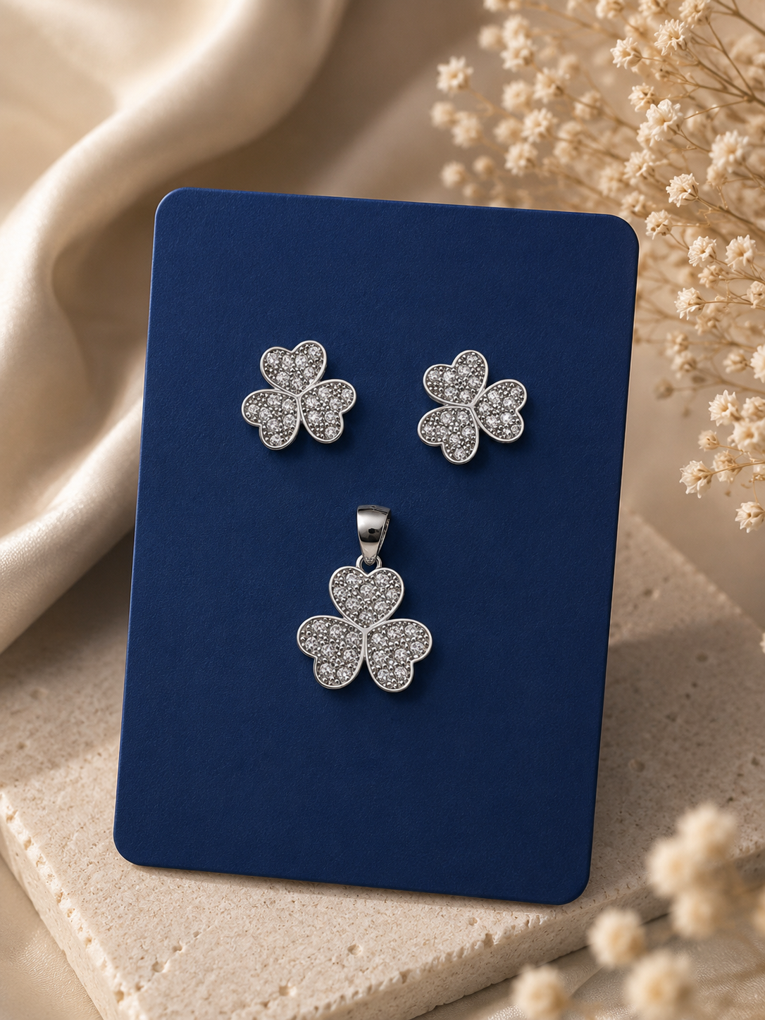 A silver-toned four-leaf clover jewelry set, including a pendant 