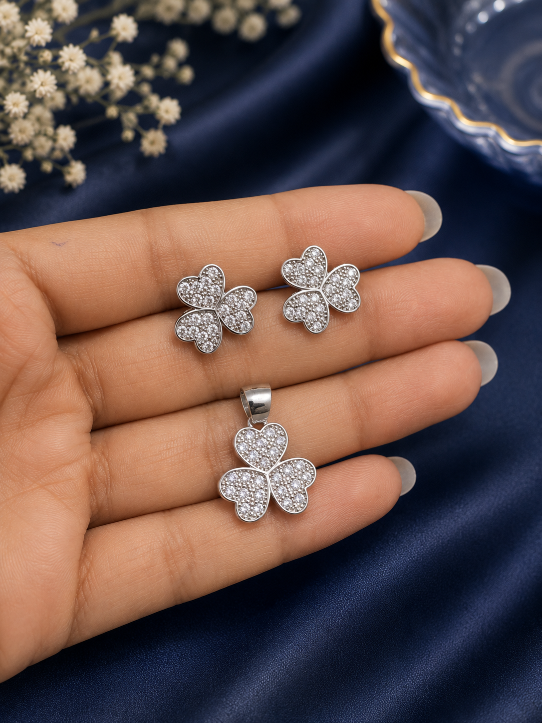 A silver-toned four-leaf clover jewelry set, including a pendant 