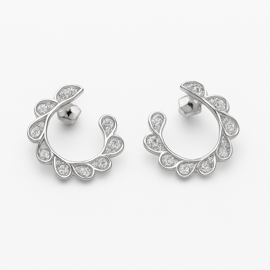 Pair of silver hoop earrings on an orange background