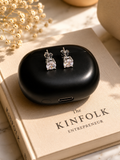 Black earrings case with silver earrings on a Kinfolk book