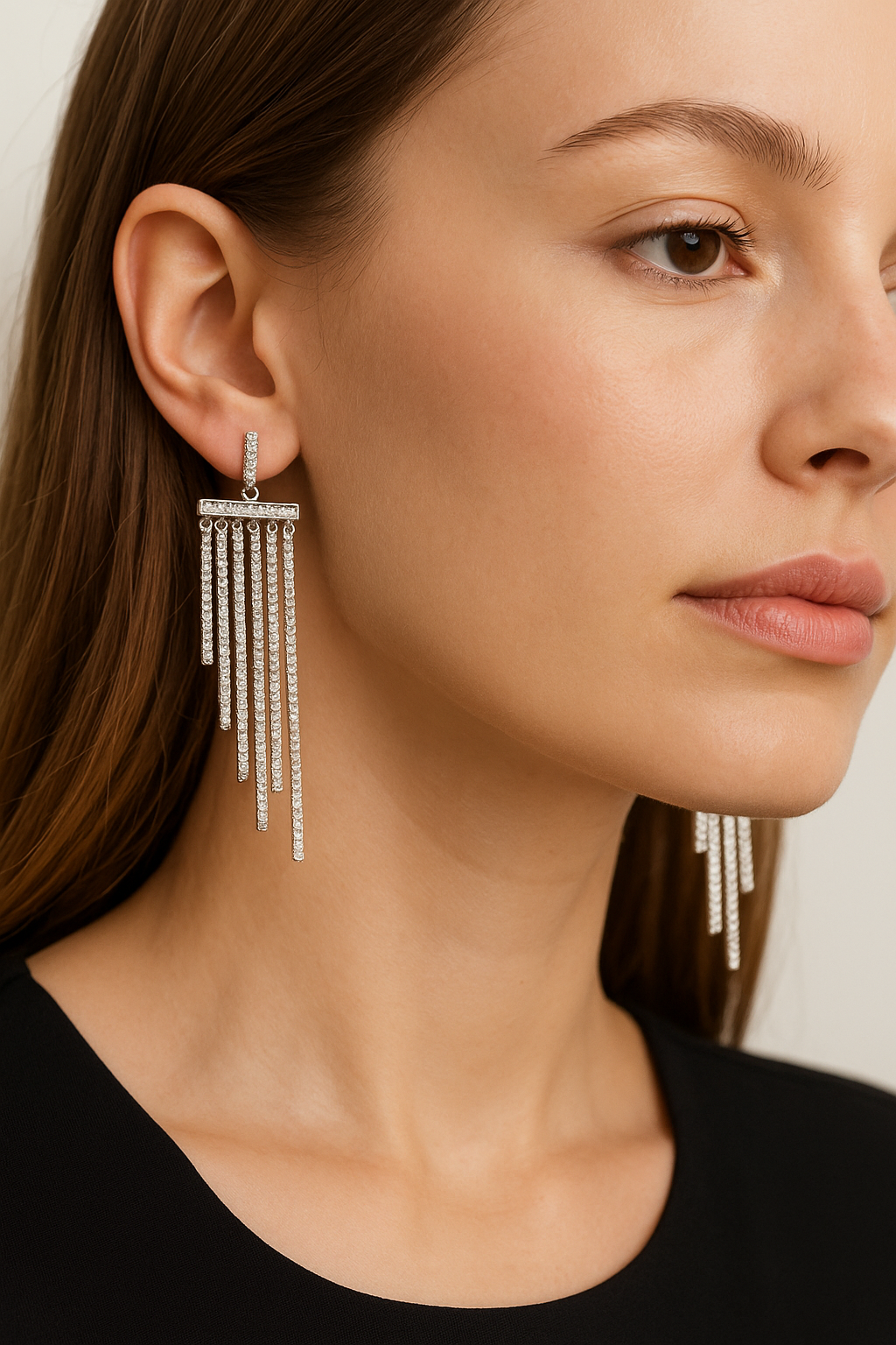 Close-up of a woman wearing a pair of dangling earrings.