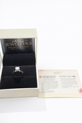 Diamond ring in a jewelry box with A&G Jewelers branding and a certificate on a white background.
