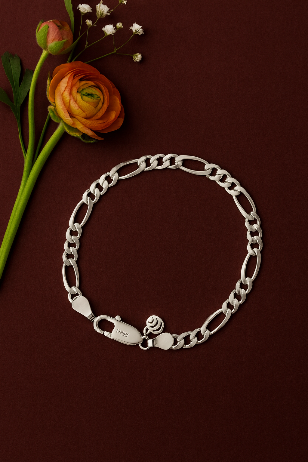 Silver chain bracelet on a brown background with flowers