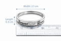 Silver ring with engraved text on a ruler for size reference