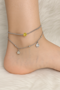 Elegant 925 silver anklet with multiple charms displayed on yellow velvet stand