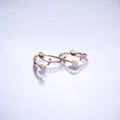 Gold ring with floral design on a light purple background
