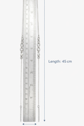 Silver anklets with a ruler for scale on a white background