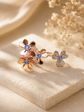 Floral earring with gemstones on a beige fabric background