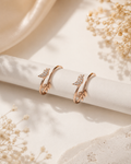 Rose gold bird toe ring pair on white background