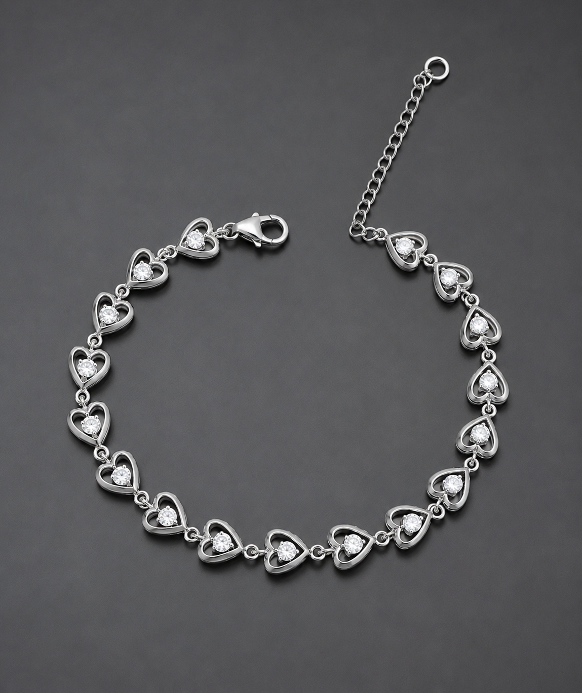 Silver bracelet with heart-shaped links on a dark gray background