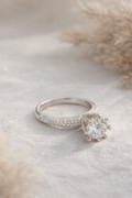Silver ring with a diamond on a soft, neutral background