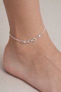 Adjustable infinity anklet pair worn on both feet in sterling silver with zircon