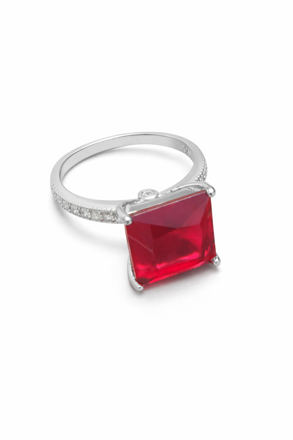 Silver ring with a red square gemstone on a white background